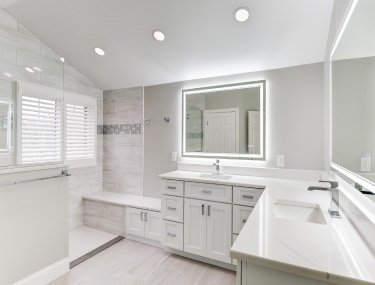 Newly remodeled white kitchen, featuring modern appliances and ample counter space.