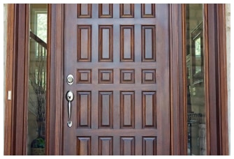 Close-up of a sturdy brown front door, adding warmth and charm to the entrance of a home.