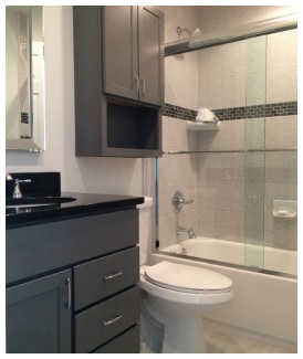 Contemporary bathroom with gray cabinets and sleek fixtures.